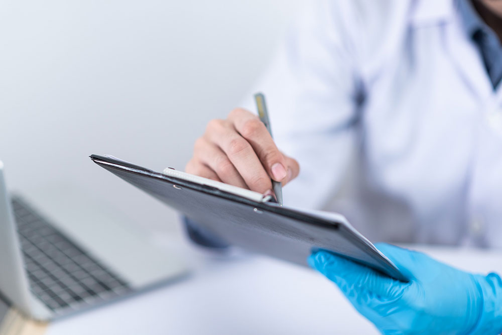 Doctor managing primary care data on tablet